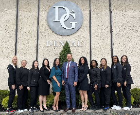 West Orange dental team members in black scrubs standing in a line with their arms crossed