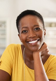 a person holding their cheek due to tooth pain