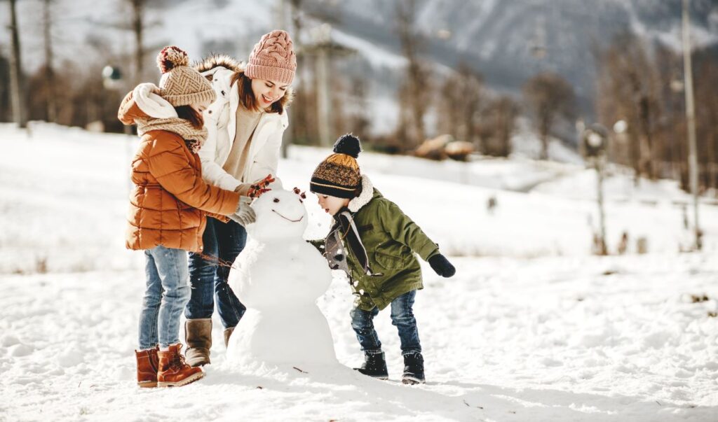 A family building a snowman